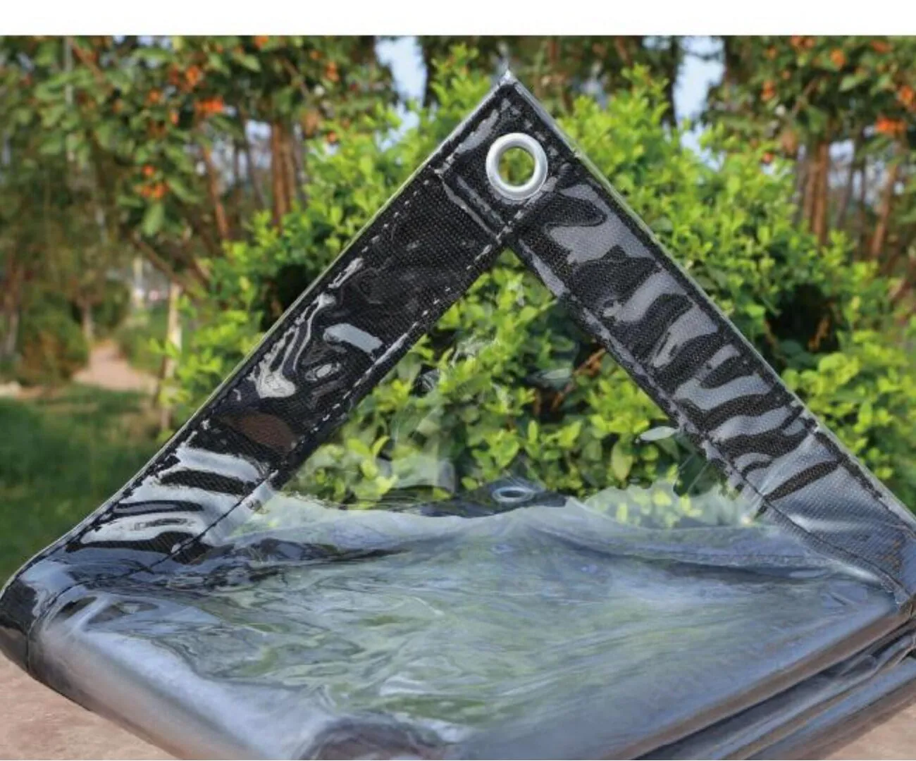 Clear transparent waterproof PVC tarpaulin with black webbing edge and metal grommets